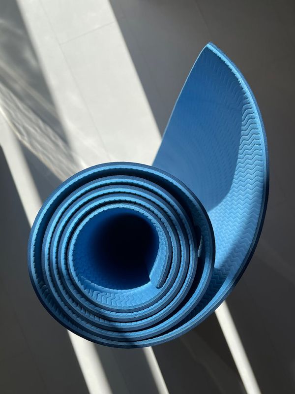 Bright and spacious room with a yoga mat on the floor.