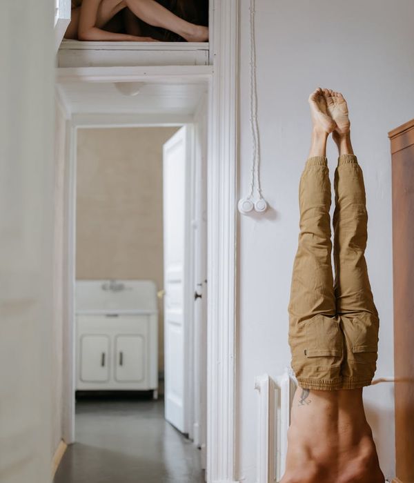 Person doing a light stretching exercise in a calm, modern room.
